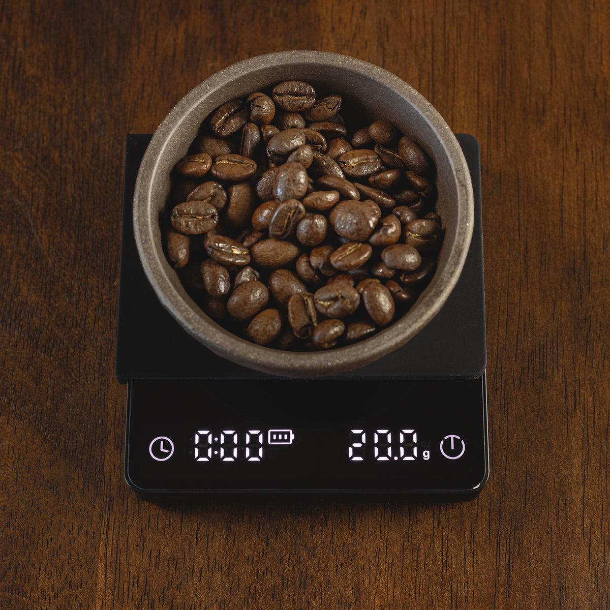Flair Espresso Scale on a wooden countertop with beans and a weight of 20 grams.