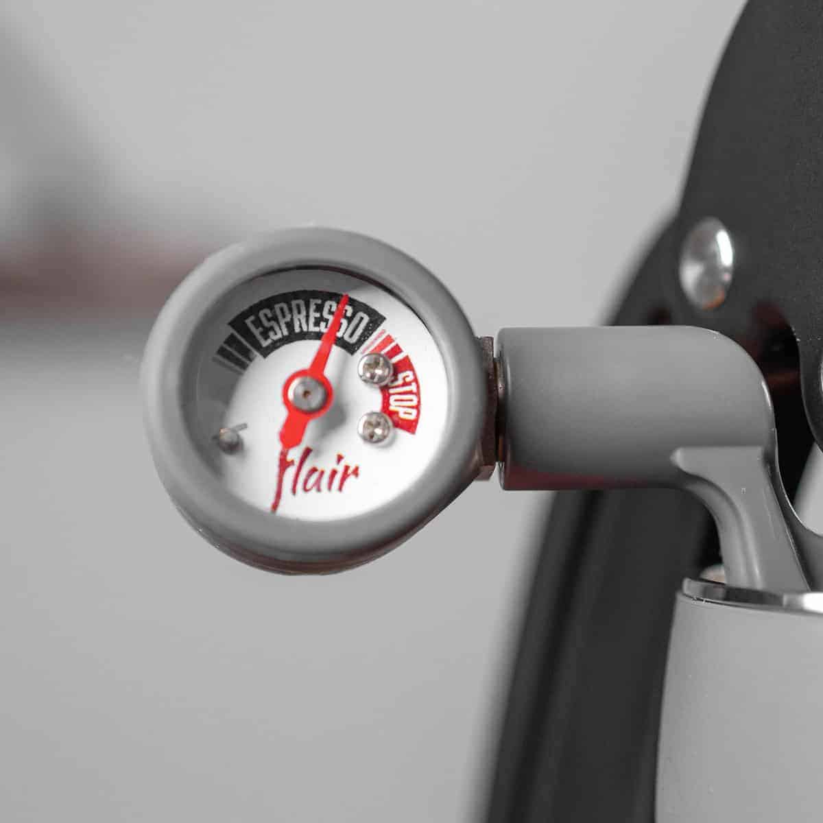 Pressure gauge on a coffee machine with 'Espresso Flair' branding.
