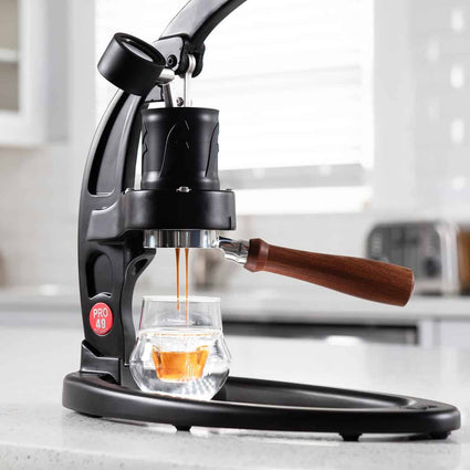 Flair 49 PRO manual espresso maker with the lever raised and brewing espresso.