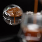 Close-up of a coffee cup with latte art, blurred background