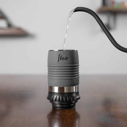 The thin heat efficient cylinder of the Flair Classic with boiling water being poured inside.