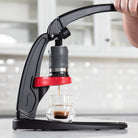 Handpresso coffee machine being used to make a shot of espresso.
